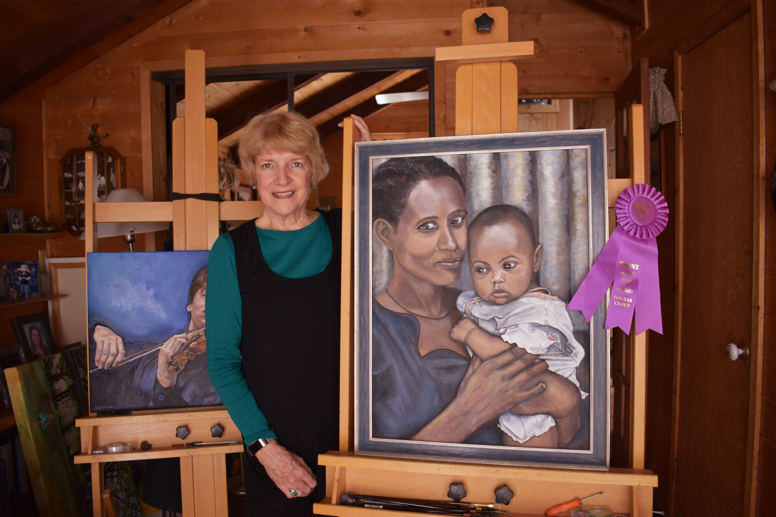 photo-of-tricia-and-her-painting-and-award